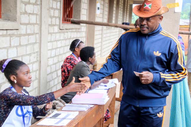 Burundi President Pierre Nkurunziza is registered by an electoral official before voting on a constitutional amendment referendum in Ngozi province, northern Burundi, May 17, 2018.