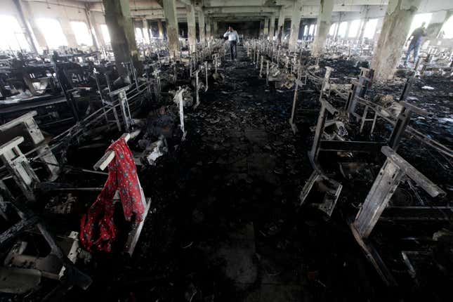 A scarf of a garment worker is seen in the burnt interior of garment factory Tazreen Fashions, after a devastating fire, in Savar November 28, 2012. Three supervisors of a Bangladeshi garments factory were arrested on Wednesday as protests over a fire that killed more than 100 people raged on into a third day, with textile workers and police clashing in the streets of a Dhaka suburb.