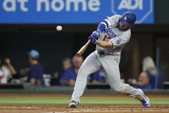 Jul 22, 2023; Arlington, Texas, USA; Los Angeles Dodgers third baseman Max Muncy (13) hits a home run against the Texas Rangers in the third inning at Globe Life Field.