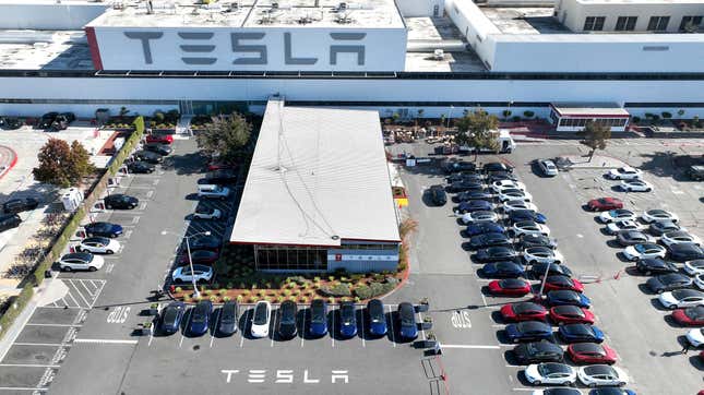 An aerial view, brand new Tesla cars lie in a parking lot at the Tesla factory on October 19, 2022 in Fremont, California.