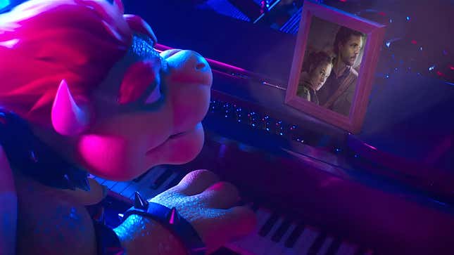 A modified Super Mario Bros. Movie still shows Bowser looking at a framed photo of Joel and Ellie from The Last of Us while playing the piano. 