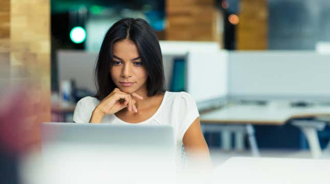 Woman studying laptop screen