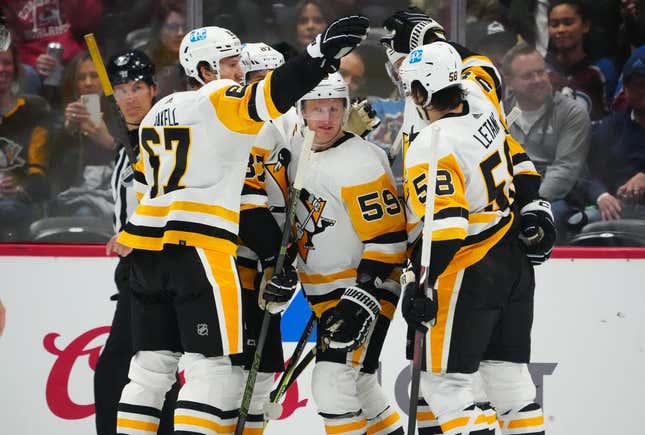 Mar 22, 2023; Denver, Colorado, USA; Pittsburgh Penguins left wing Jake Guentzel (59) celebrates his goal with right wing Rickard Rakell (67) and defenseman Kris Letang (58) and center Sidney Crosby (87) in the second period against the Colorado Avalanche at Ball Arena.