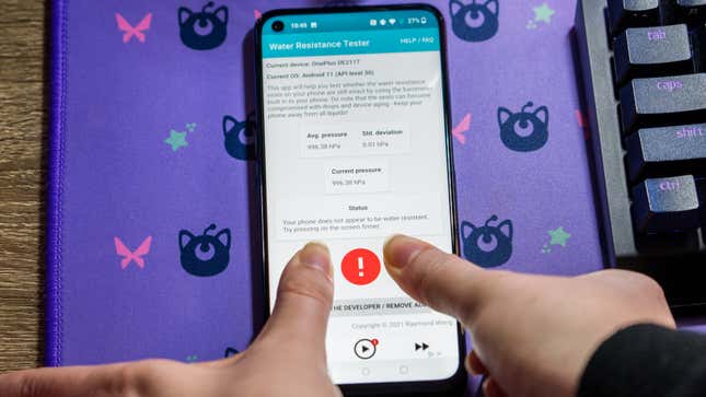 A photo of my two thumbs pressing down on an Android smartphone with the water resistance app open