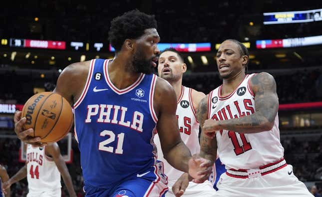 Oct 29, 2022; Chicago, Illinois, USA; Philadelphia 76ers center Joel Embiid (21) is defended by Chicago Bulls forward DeMar DeRozan (11) during the second half at United Center.