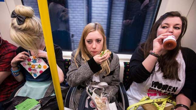 Women eating sandwiches on train
