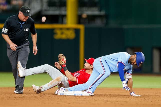 Apr 2, 2023; Arlington, Texas, USA; Texas Rangers second baseman Marcus Semien (2) is thrown out at 2nd against the Philadelphia Phillies at Globe Life Field.