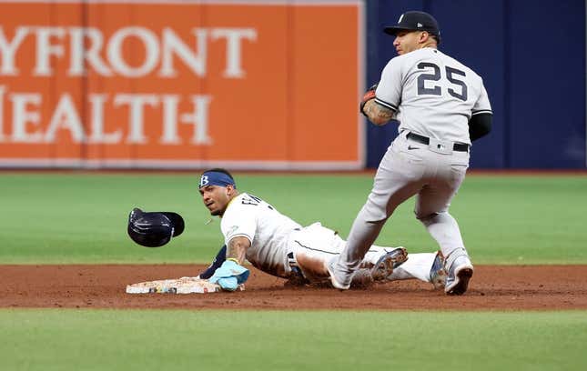 May 6, 2023; St. Petersburg, Florida, USA;  Tampa Bay Rays shortstop Wander Franco (5) steals second base as New York Yankees second baseman Gleyber Torres (25) attempted to tag him out during the fifth inning at Tropicana Field.