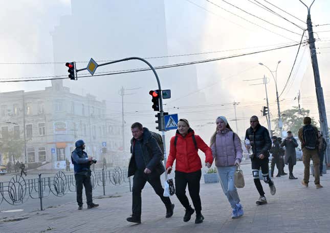 Local residents run away after a drone attack in Kyiv on October 17, 2022, amid the Russian invasion of Ukraine.