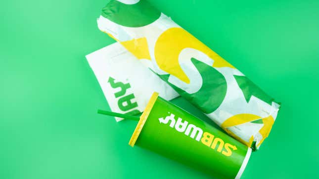 subway food in wrappers on green background