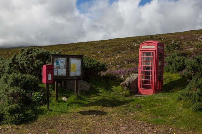 A telephone booth and mailbox in the meadows of Laid.