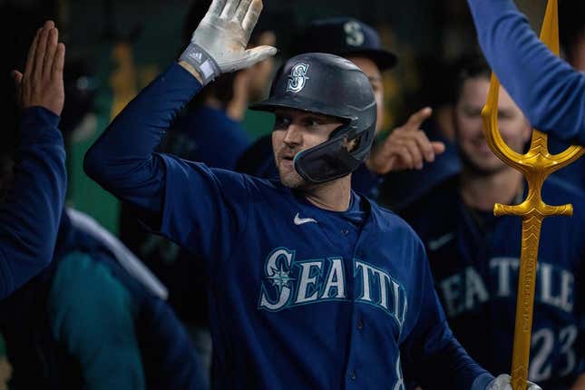 May 3, 2023; Oakland, California, USA; Seattle Mariners left fielder AJ Pollock (8) celebrates in the dugout after hitting a solo home run against the Oakland Athletics during the ninth inning at Oakland-Alameda County Coliseum.