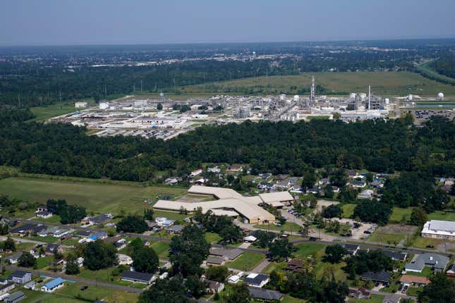 The Fifth Ward Elementary School and residential neighborhoods sit near the Denka Performance Elastomer Plant, back, in Reserve, La., Sept. 23, 2022. Federal officials are suing Louisiana chemical maker Denka Tuesday, Feb. 28, 2023, alleging that it presented an unacceptable cancer risk to the nearby majority-Black community and demanding cuts in toxic emissions.

