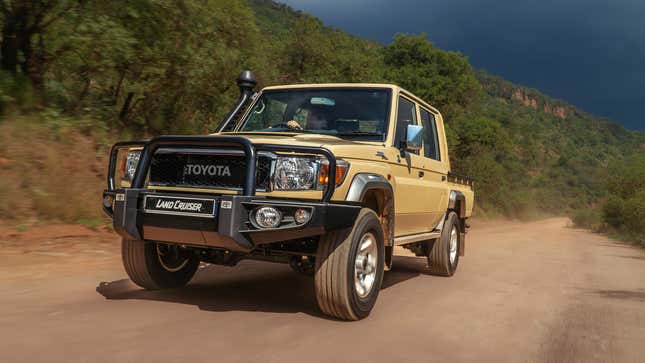 Front-quarter view of a new Toyota Land Cruiser 70 pickup in beige yellow