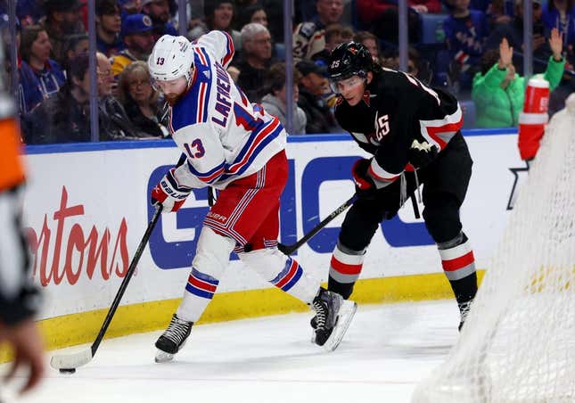 Mar 11, 2023; Buffalo, New York, USA;  New York Rangers left wing Alexis Lafreni  re (13) controls the puck as Buffalo Sabres defenseman Owen Power (25) defends during the first period at KeyBank Center.