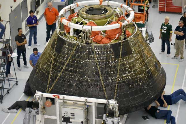 NASA engineers inspecting Orion’s heat shield shortly after the Artemis 1 mission. 
