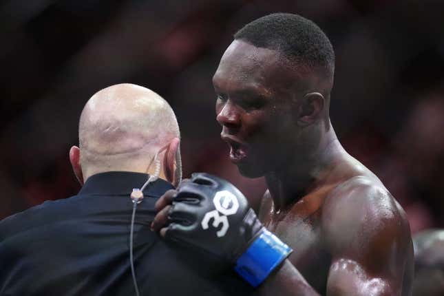 Apr 8, 2023; Miami, Florida, USA; Israel Adesanya (blue gloves) reacts to defeating Alex Pereira (red gloves) during UFC 287 at Miami-Dade Arena.