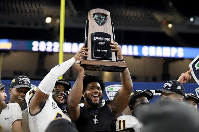 Dec 3, 2022; Detroit, Michigan, USA;  Toledo linebacker Jackson Barrow (42) (left) and Desjuan Johnson (right) celebrate with the MAC Championship trophy after beating Ohio University at Ford Field.