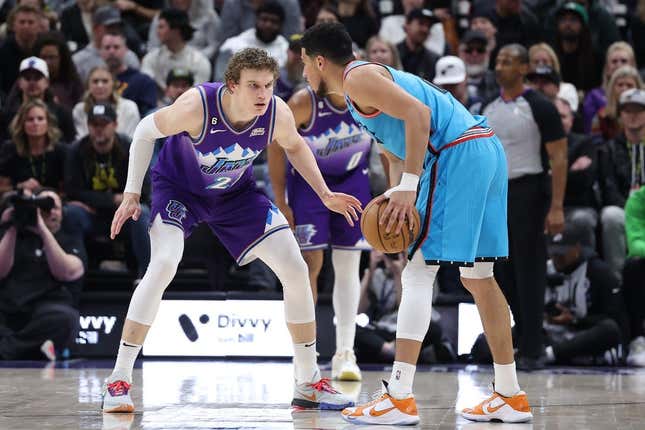 Mar 27, 2023; Salt Lake City, Utah, USA; Utah Jazz forward Lauri Markkanen (23) defends Phoenix Suns guard Devin Booker (1) in the second quarter at Vivint Arena.