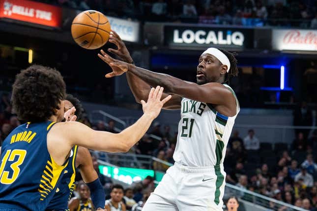 Mar 29, 2023; Indianapolis, Indiana, USA; Milwaukee Bucks guard Jrue Holiday (21) passes the ball while Indiana Pacers forward Jordan Nwora (13) defends in the second quarter at Gainbridge Fieldhouse.