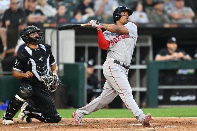 June 23, 2023;  Chicago, Illinois, USA;  Boston Red Sox infielder Raphael Devers (11) hits a two-run home run in the fourth inning against the Chicago White Sox at Guaranteed Rate Field.
