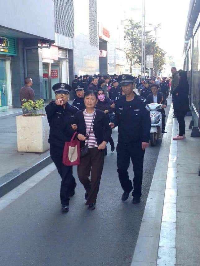 An investor taken away by police near the CSRC headquarters.