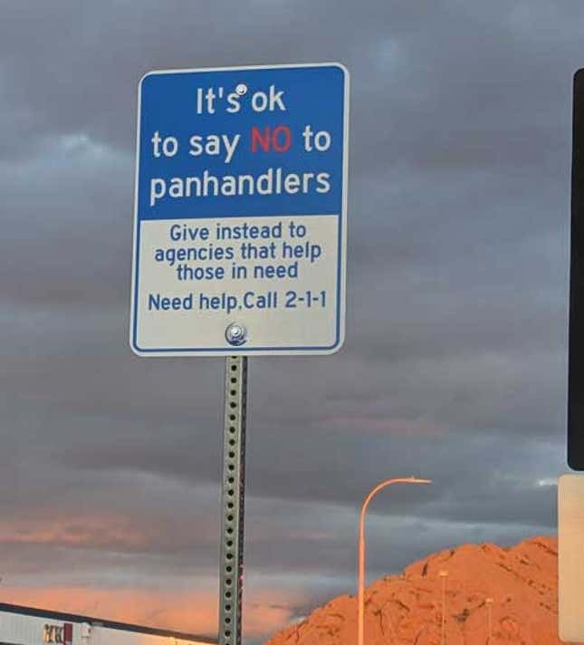 Street sign that reads "its ok not to say no to panhandlers.Give instead to those agencies that help. Call 2-1-1-".