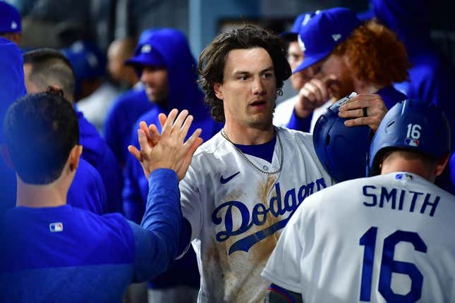 Mar 30, 2023; Los Angeles, California, USA; Los Angeles Dodgers center fielder James Outman (33) is greeted after scoring a run against the Arizona Diamondbacks during the eighth inning at Dodger Stadium.