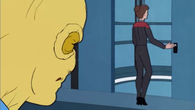 A yellow sex-lizard-man watches as Captain Janeway enters a Voyager elevator.
