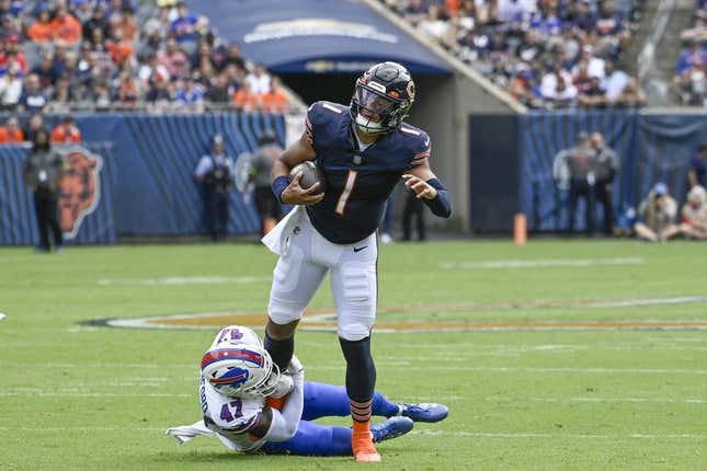 Aug 26, 2023; Chicago, Illinois, USA;  Chicago Bears quarterback Justin Fields (1) is stopped by Buffalo Bills cornerback Christian Benford (47) during the first half  at Soldier Field.