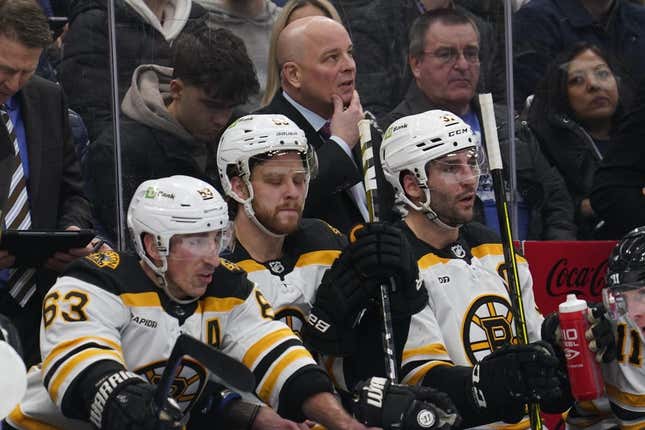 Feb 1, 2023; Toronto, Ontario, CAN; Boston Bruins head coach Jim Montgomery, forward Brad Marchand (63) and forward Patrice Bergeron (37) on the bench against the Toronto Maple Leafs at Scotiabank Arena.