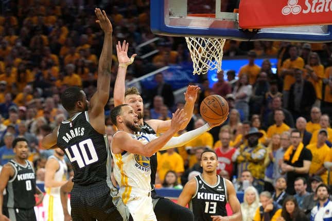 Apr 23, 2023; San Francisco, California, USA; Golden State Warriors guard Stephen Curry (center front) shoots against Sacramento Kings forward Harrison Barnes (40) and forward Domantas Sabonis (center back) during the fourth quarter of game four of the 2023 NBA playoffs at Chase Center.