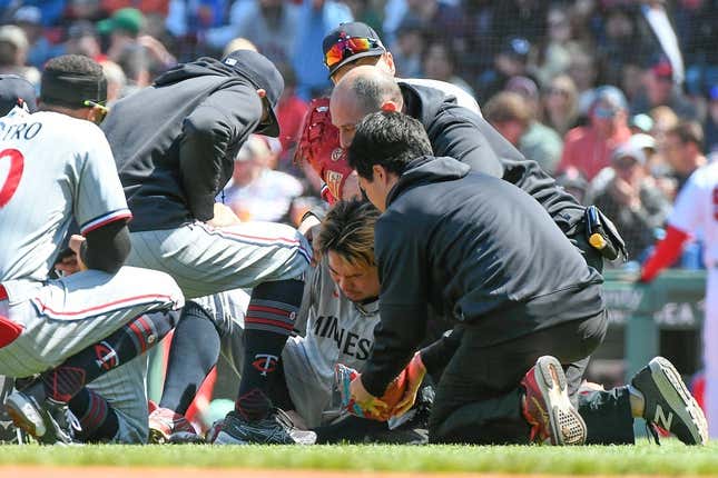 Apr 20, 2023; Boston, Massachusetts, USA; Minnesota Twins starting pitcher Kenta Maeda (18) is examined  after being struck by a ball hit by Boston Red Sox center fielder Jarren Duran (not pictured) at Fenway Park.