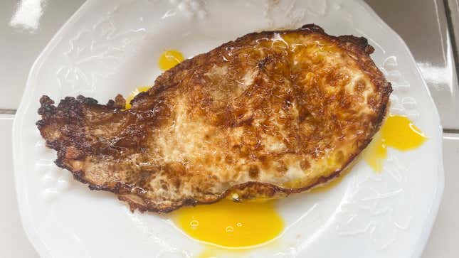The bottom of an egg fried in butter.