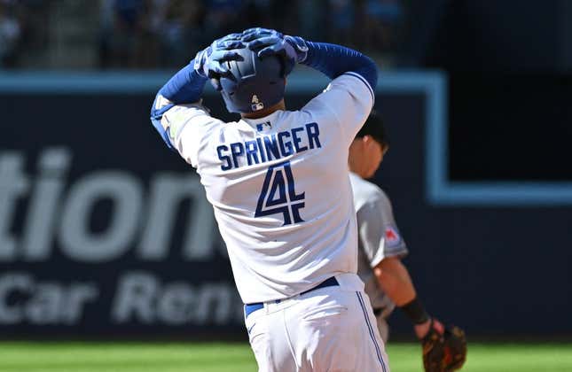 Aug 27, 2023; Toronto, Ontario, CAN; Toronto Blue Jays right fielder George Springer (4) reacts after his fly ball to the center field wall is caught by Cleveland Guardians center fielder Myles Straw (not pictured) in the eighth  inning at Rogers Centre.