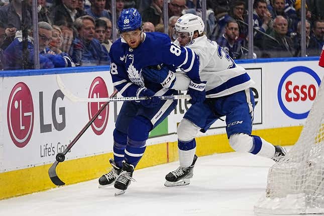 Apr 18, 2023; Toronto, Ontario, CAN; Tampa Bay Lightning forward Brandon Hagel (38) knocks the puck away from Toronto Maple Leafs forward William Nylander (88) during the first period of game one of the first round of the 2023 Stanley Cup Playoffs at Scotiabank Arena.