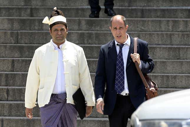 The president of the Burmese Rohingya Organisation UK, Tun Khin, left, and Argentine human rights lawyer Tomas Ojea Quintana left a court in Buenos Aires on Nov. 13, 2019.