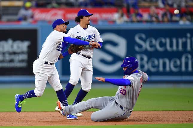 Apr 17, 2023; Los Angeles, California, USA; New York Mets first baseman Pete Alonso (20) is out at second as Los Angeles Dodgers shortstop Miguel Rojas (11) throws to first during the second inning at Dodger Stadium.