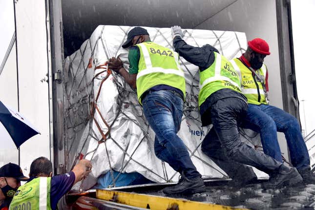 Workers load South Africa’s first Covid-19 vaccine doses at OR Tambo airport in Johannesburg on Feb. 1.