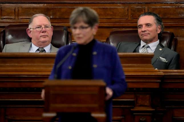 Daniel Hawkins (l.) passed the bill, overriding a veto by Gov. Laura Kelly (center)