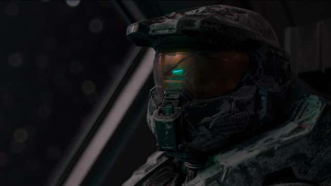 The Master Chief, with his helmet on, looks to the camera.