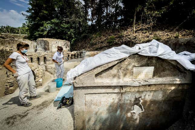 Team members inspecting the tomb.