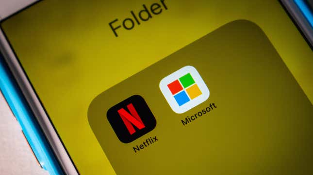 A phone with the word folder at the top of the screen holding both the Netflix and Microsoft app icons.