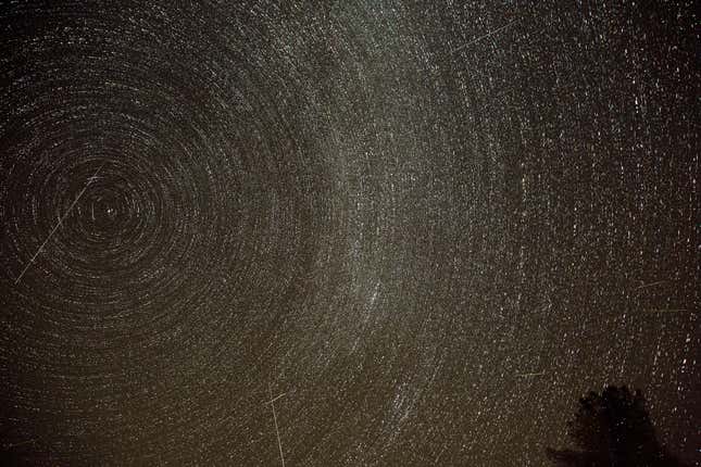 A long-exposure photo shows meteors in the context of stars’ movement.