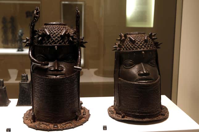 Two heads of a royal ancestor from the former Benin Kingdom, a part of modern-day Nigeria, 18th century (R) and 19th century (L) are displayed at the Quai Branly Museum in Paris, France, Nov 23, 2018.