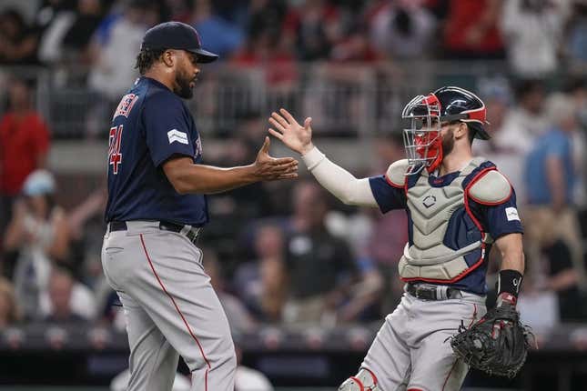 May 10, 2023; Cumberland, Georgia, USA; Boston Red Sox relief pitcher Kenley Jansen (74) reacts with catcher Connor Wong (12) after recording his 400th career save against the Atlanta Braves at Truist Park.