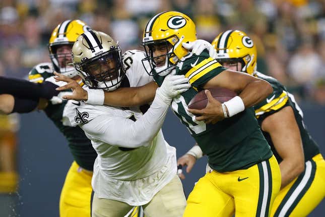 Aug 19, 2022; Green Bay, Wisconsin, USA;  Green Bay Packers quarterback Jordan Love (10) is tackled by New Orleans Saints defensive end Taco Charlton (54) during the second quarter at Lambeau Field.
