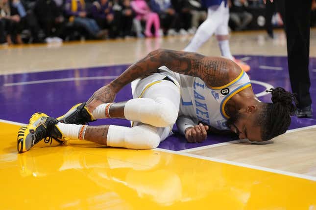 Feb 23, 2023; Los Angeles, California, USA; Los Angeles Lakers guard D&#39;Angelo Russell (1) reacts after suffering a right ankle sprain after the game in the first half at Crypto.com Arena.