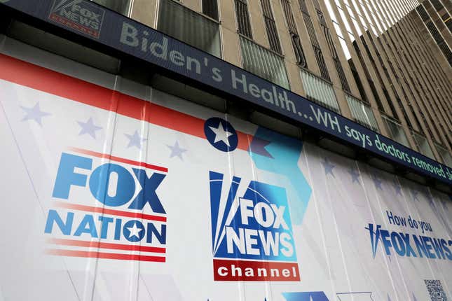 The facade of Fox News headquarters in New York shows a headline reading "Biden's Health...WH says doctors removed" and then the text is cut off. Various Fox News logos are pasted to the facade.