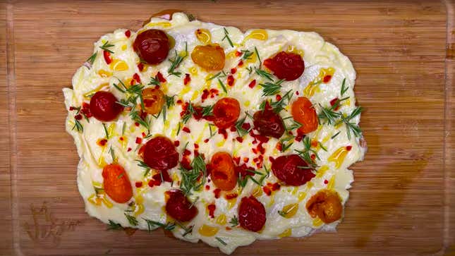 Butter Board seen from above with tomatoes and rosemary
